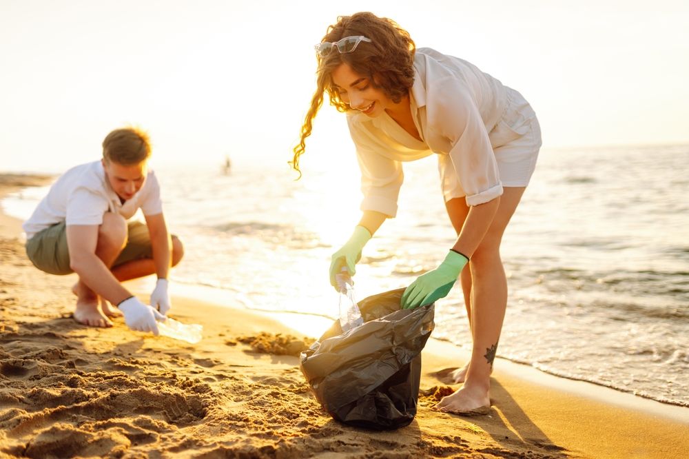 tineri care curata plaja de gunoaie